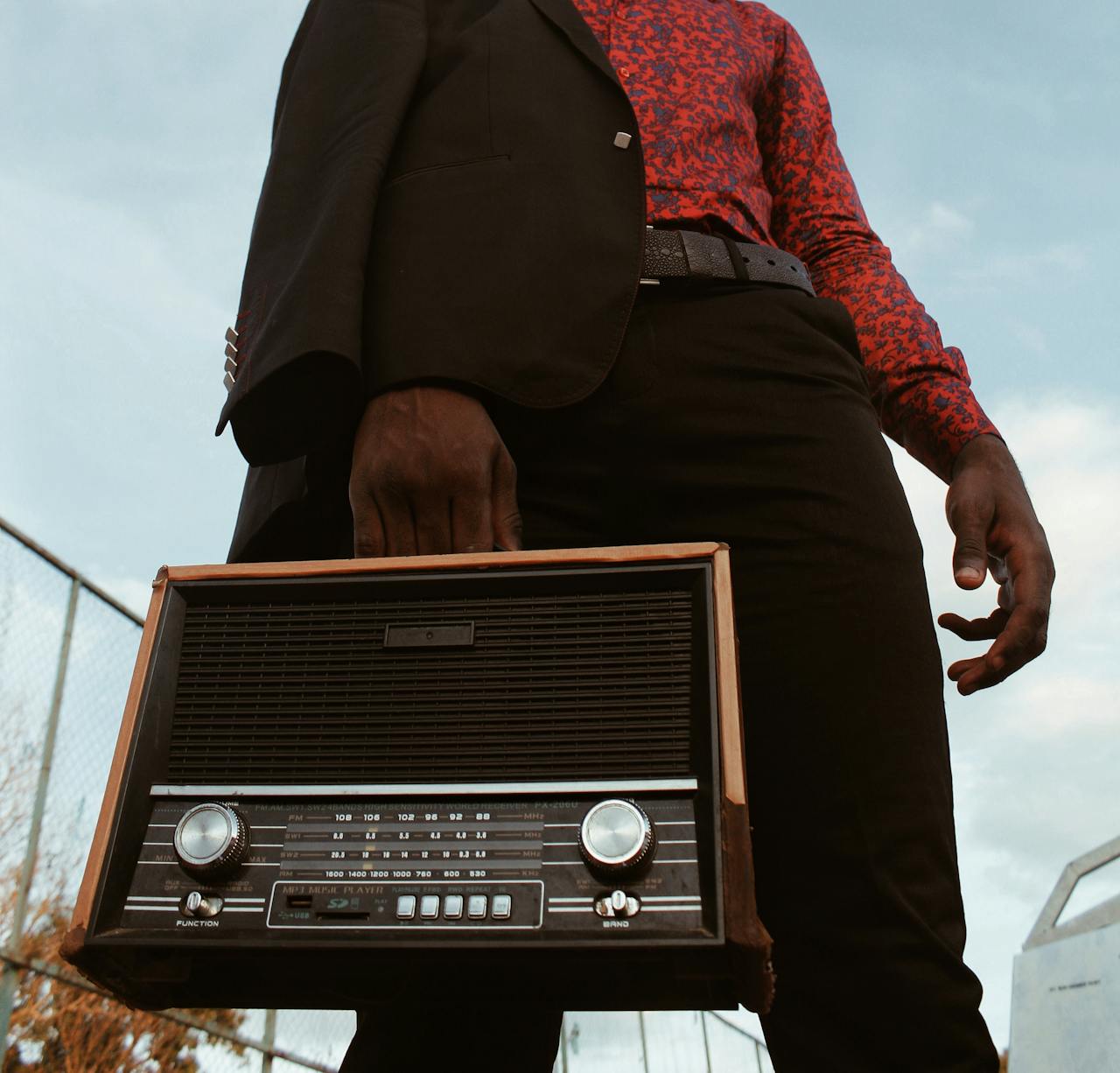 Low-angle Photography of Man Carrying a Short-wave Radio